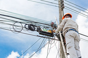 An electrician following the health and safety rules by wearing full length pants