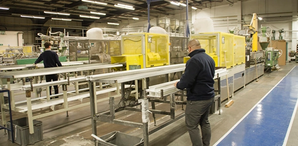 50 Years of British Manufacturing - 2 men on an extrusion line, PVCu cable management