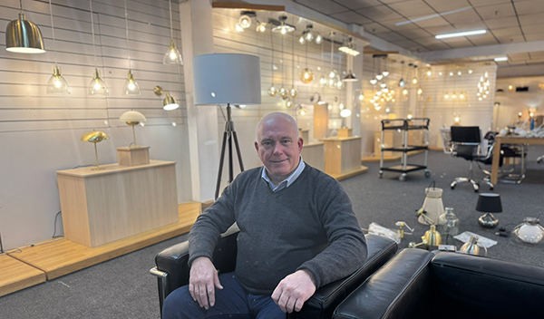 Gary Pearson, New Area Sales Manager at Forum Lighting, instrumental in company growth, and is seated in a lighting showroom on a back leather armchair
