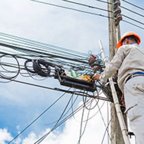 An electrician following the health and safety rules by wearing full length pants