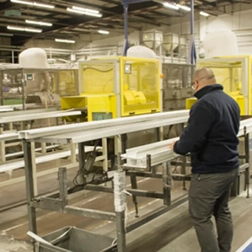 50 Years of British Manufacturing - 2 men on an extrusion line, PVCu cable management