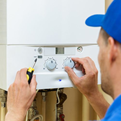 Man fixing the boiler after using the Boiler Guide