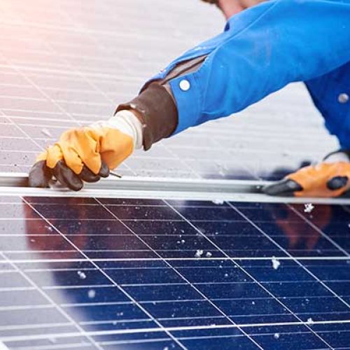 Cropped horizontal shot of a male worker installing solar panels on a power plant using elternative renewable energy copyspace modern technology nature environment concept.