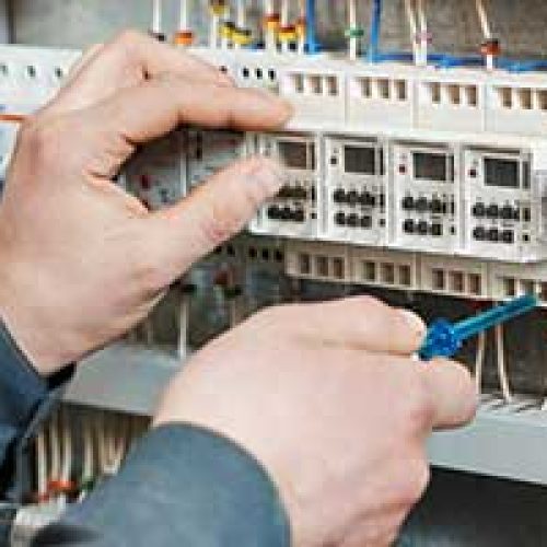 Electrician working on board adhering to electrical safety 